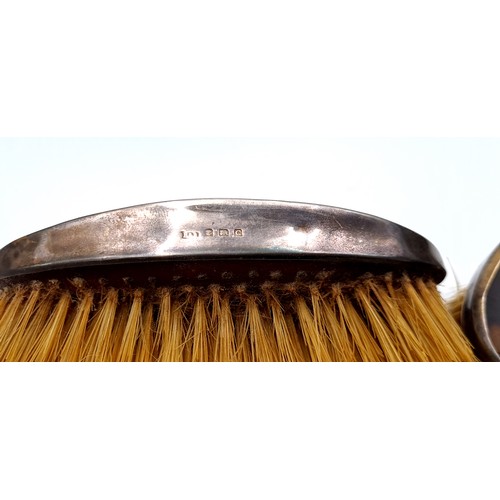 47 - A pair of silver backed tortoise shell clothes brushes. Hallmarked Birmingham - 1927. Items in come ... 