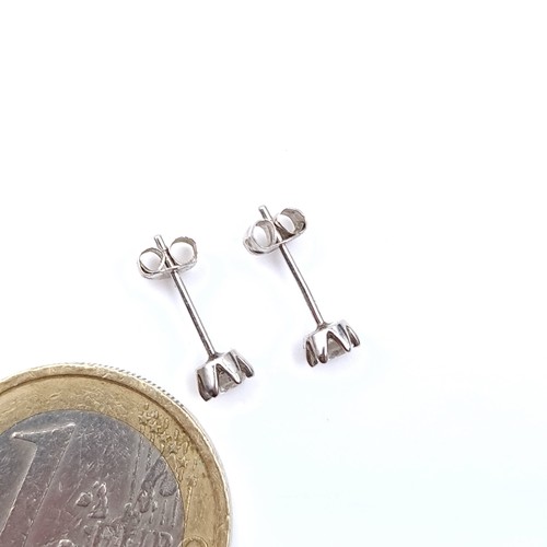 51 - Star Lot : A beautiful pair of diamond stud earrings with platinum posts. Total weight - 0.88 grams.... 