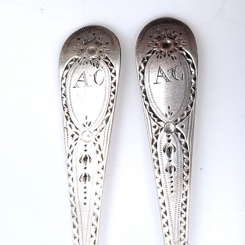 501 - Two sterling silver teaspoons hallmarked London - 1829. Set with attractive bright cut detailing. Le... 