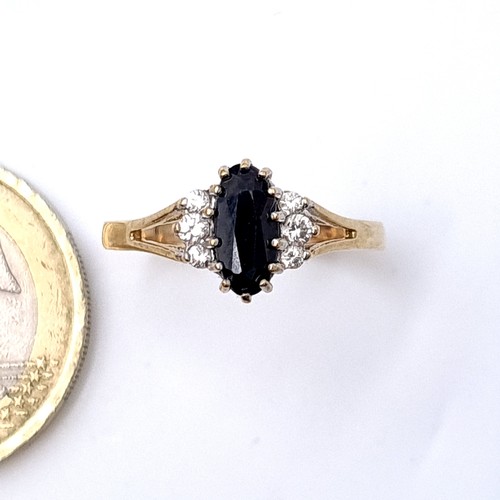 5 - Star Lot : A stunning  arge oval sapphire  ring with gemstone mount set in nine carat gold. Ring siz... 