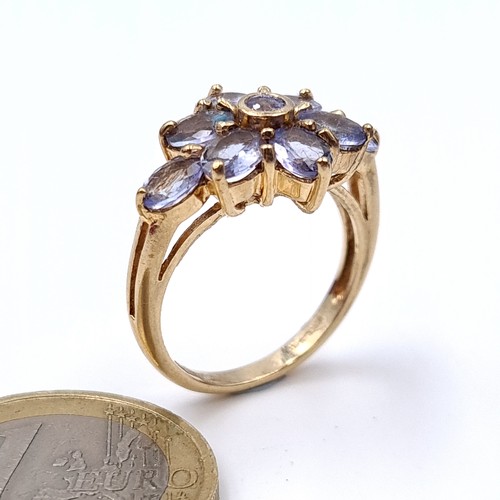 7 - Star Lot : A stunning heavy tanzanite flower ring set in nine carat gold. Ring size - O. Weight - 4.... 