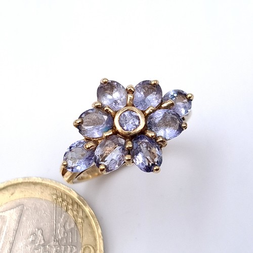 7 - Star Lot : A stunning heavy tanzanite flower ring set in nine carat gold. Ring size - O. Weight - 4.... 