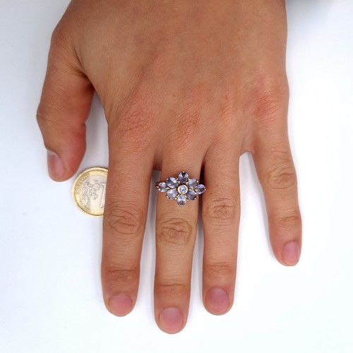 7 - Star Lot : A stunning heavy tanzanite flower ring set in nine carat gold. Ring size - O. Weight - 4.... 