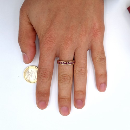 9 - Star Lot : A very pretty nine stone ruby half eternity ring set in nine carat gold (375) Ring size -... 