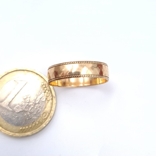 13 - An attractive nine carat gold (375) gold band ring. Ring size - N. Weight - 1.7 grams. Boxed.