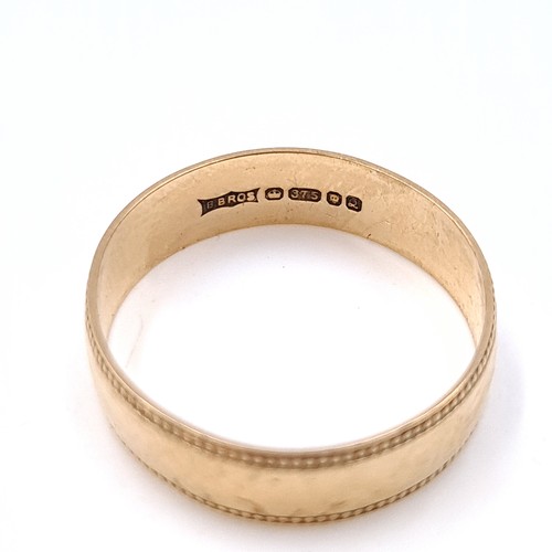 13 - An attractive nine carat gold (375) gold band ring. Ring size - N. Weight - 1.7 grams. Boxed.