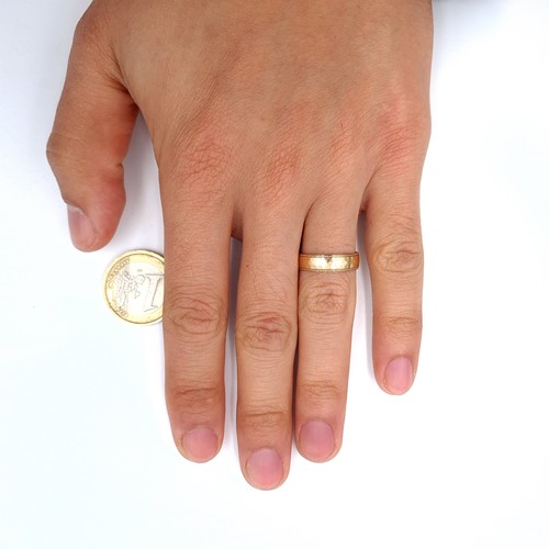 13 - An attractive nine carat gold (375) gold band ring. Ring size - N. Weight - 1.7 grams. Boxed.