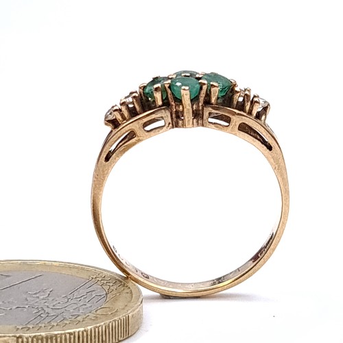 15 - Star Lot : A nine carat gold (375) emerald and diamond set ring. Ring size - N. Weight - 2.1 grams. ... 