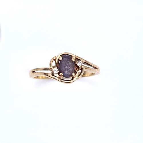 19 - Star Lot : A nine carat gold (375) blue sapphire and diamond  ring with gemstone twist mount. Ring s... 