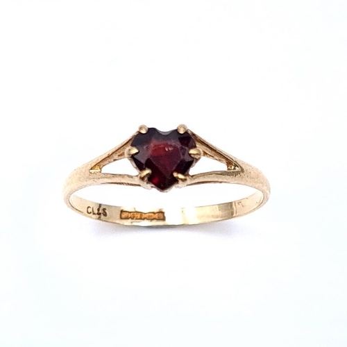 22 - A heart shaped garnet stone ring set in nine carat gold (375) Ring size - K. Weight 1 grams. Boxed.