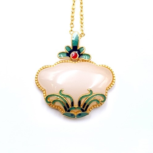 24 - A pretty silver gilt jade floral carved white jade pendant with chain. Length of chain - 42 cms.