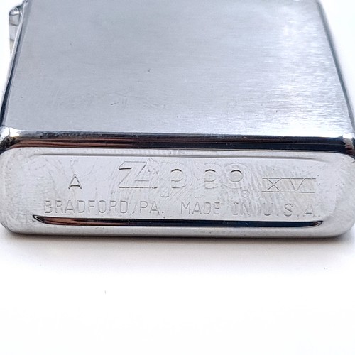 26 - A Zippo brushed chrome lighter. Zippo XV 
Made in Bradford, PA USA