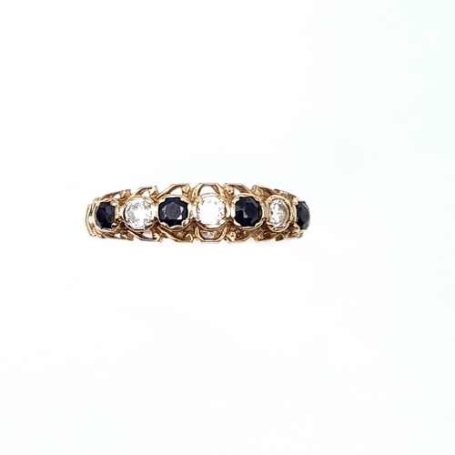 21 - A seven stone gem set half eternity ring set in nine carat gold. Ring size - O. Weight - 1.73 grams.... 