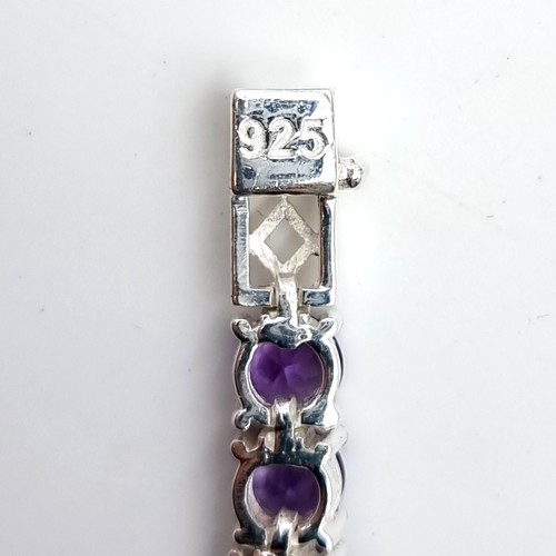 966 - Star lot : A very attractive 32 gemstone amethyst line bracelet set in sterling silver. Beautiful pi... 