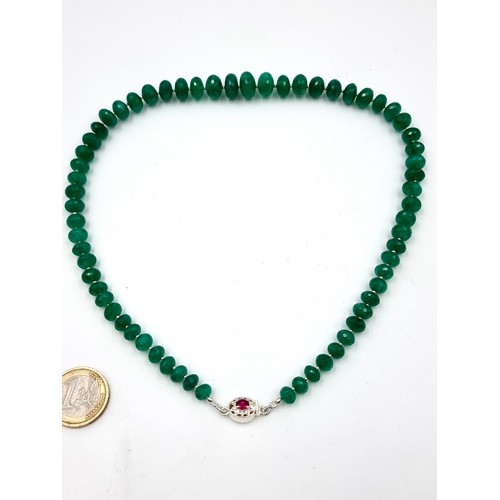 968 - Star Lot : A super example of a graduated emerald gemstone necklace with a ruby stone set clasp set ... 