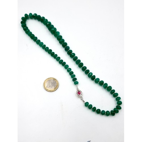 968 - Star Lot : A super example of a graduated emerald gemstone necklace with a ruby stone set clasp set ... 