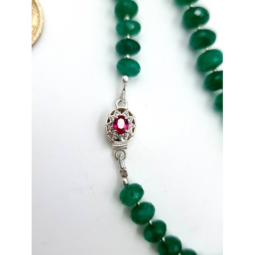 968 - Star Lot : A super example of a graduated emerald gemstone necklace with a ruby stone set clasp set ... 