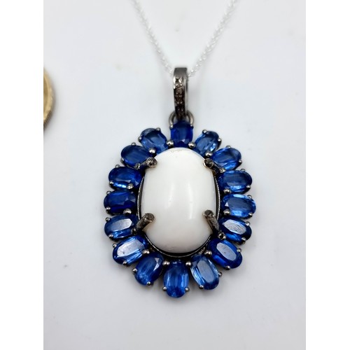 970 - Star Lot : A beautiful white cabochon polished Opal gemstone pendant with super sapphire stone surro... 