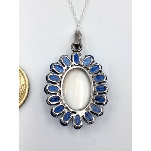 970 - Star Lot : A beautiful white cabochon polished Opal gemstone pendant with super sapphire stone surro... 