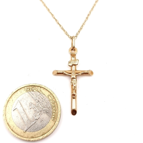 1 - A nine carat gold crucifix cross and chain. Cross dimensions: 3 x 1.5 cms. Length of chain - 48 cms.... 