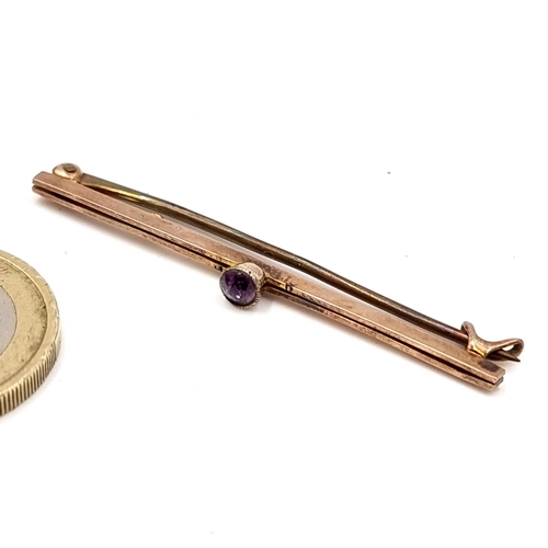 11 - A nine carat gold amethyst set bar brooch. Length - 5 cms. Weight - 1.8 grams. Boxed.