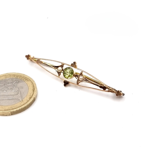 12 - A nine carat gold Peridot stone brooch set with seed pearl detailing. Length - 5 cms. Weight - 1.54 ... 