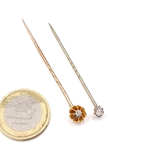 16 - Two diamond stick pins. The first in daisy setting. Length - 5.5 cms. (Est. weight of diamonds - 0.1... 