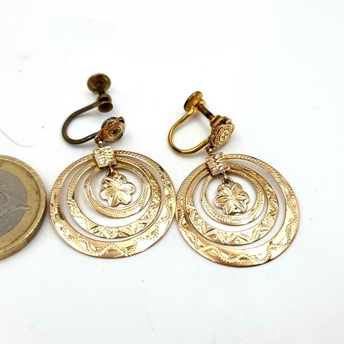 19 - A pair of nine carat gold circular mounted clasp earrings. Total earring weight - 4.67 grams. Boxed.