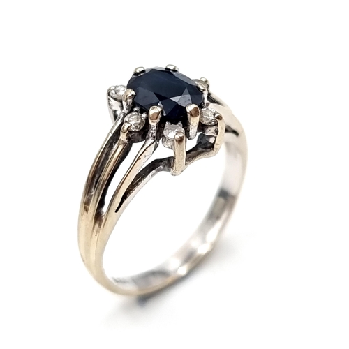 2 - Star Lot : An 18ct  white gold ring stamped 750 set with dark sapphire stone set with diamond accent... 