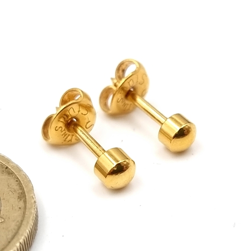 20 - A pair of nine carat gold stud earrings. . Boxed.