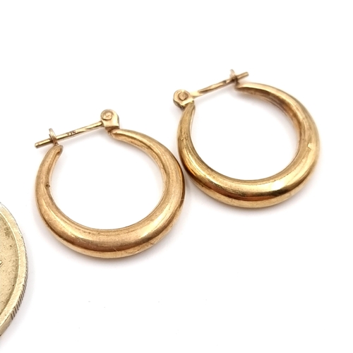 24 - A pair of nine carat gold hoop earrings. Suitable for pierced ears. Total weight - 1.29 grams. Boxed... 