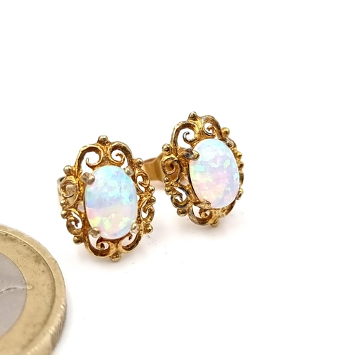 26 - A pair of fire opal stud earrings set in nine carat gold with attractive filigree mount. Total weigh... 