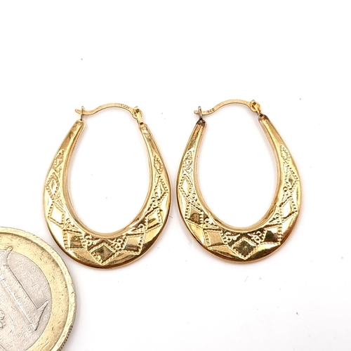 38 - A pair of nine carat gold horseshoe shaped earrings - suitable for pierced ears. Weight - 0.76 grams... 