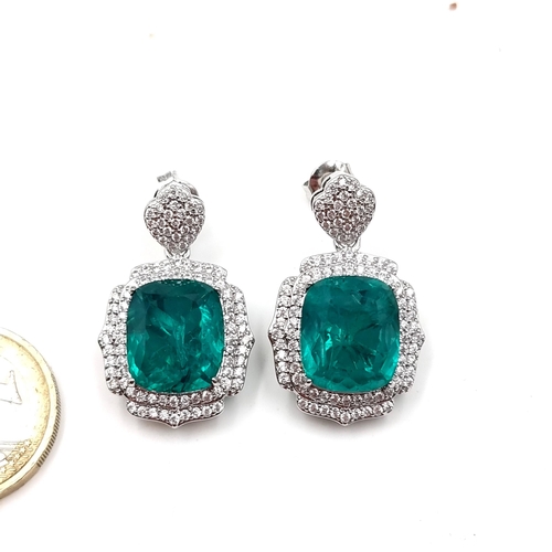 46 - A beatiful pair of lab created Emerald stud earrings set in sterling silver. Weight - 11.2 grams. Cr... 