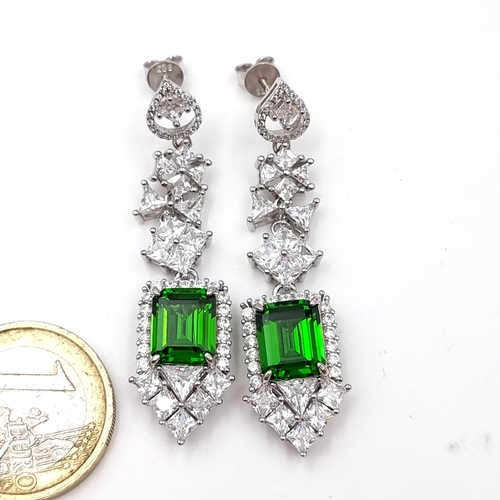 54 - A stunning pair of Lab Created Emerald facet cut stud earrings with gemstone surround. Weight - 12.7... 