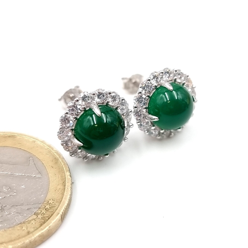 55 - A stunning pair of Lab Created Emerald facet cut stud earrings with gemstone surround. Weight - 4.46... 