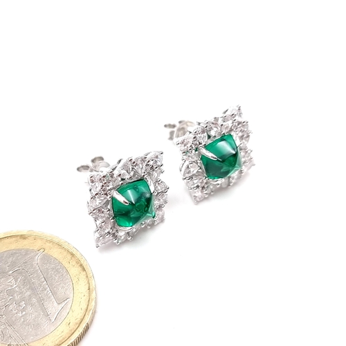 57 - A stunning pair of Lab Created Emerald facet cut stud earrings with gemstone surround. Weight - 5.97... 