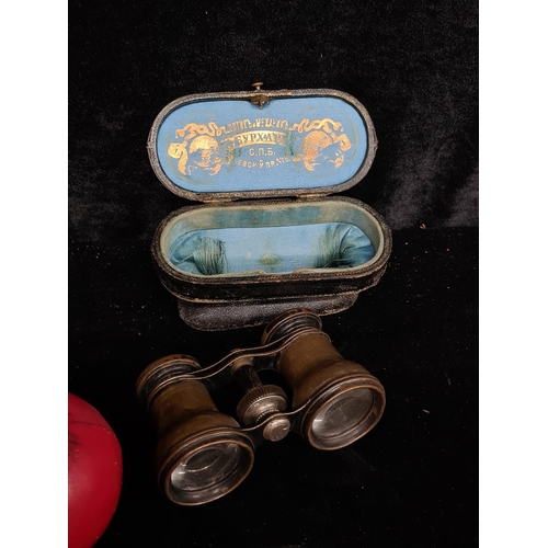 197 - A very nice example of antique brass opera binoculars with leather case which is made by optical mec... 