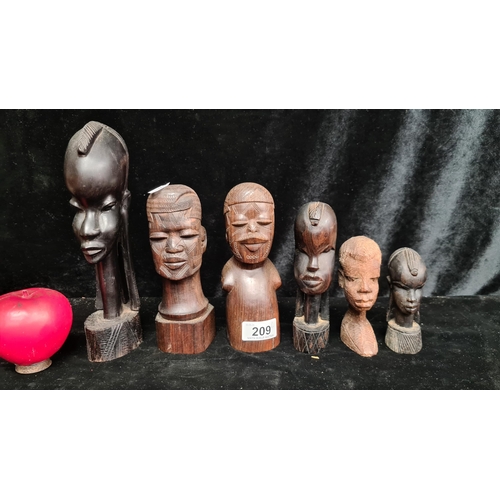 209 - Six wooden African tribal hand carved busts in a variety of sizes. Nice little collection.