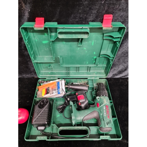 218 - A Bosch PSB 12 VE-2 cordless drill inclusive of battery, charger and a selection of bits and screws.... 