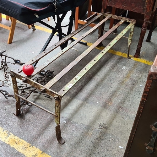 479 - Star Lot : A Victorian antique wrought iron bench featuring a simple sturdy design with bolt fitting... 