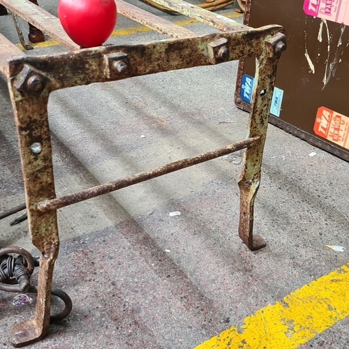 479 - Star Lot : A Victorian antique wrought iron bench featuring a simple sturdy design with bolt fitting... 