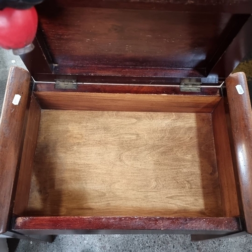 489 - A vintage oak piano stool with green leather seat and internal storage compartment for sheet music.