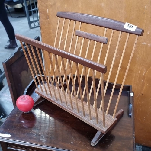 492 - Mid-century modern teak and aframosa spindle side magazine rack.