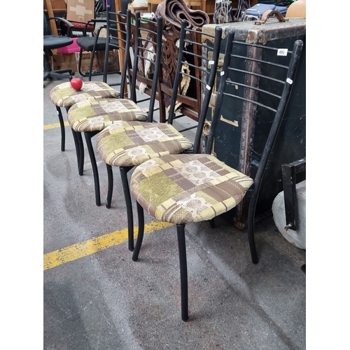 493 - A set of four vintage metal frame chairs with patchwork-patterned cushioned seats. Black frames with... 