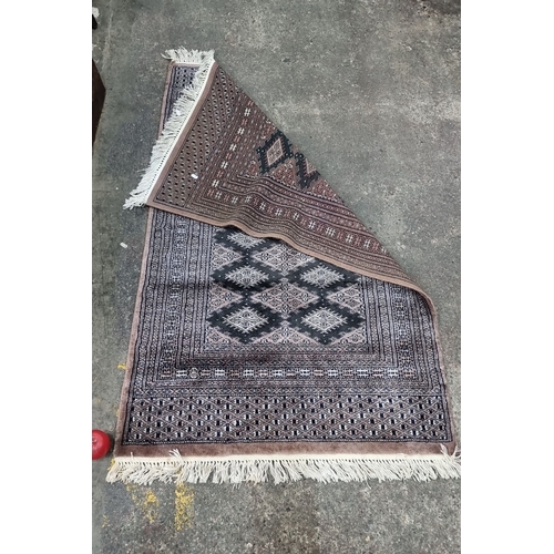 494 - Star lot : A beatiful handwoven oriental rug featuring intricate geometric diamond patterns, bordere... 