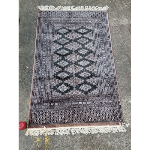 494 - Star lot : A beatiful handwoven oriental rug featuring intricate geometric diamond patterns, bordere... 