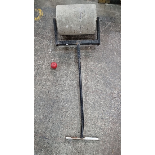 499 - A very heavy Manual concrete lawn roller with metal frame and granite roller.