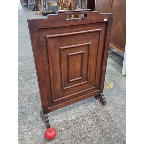 500 - An antique handsome wooden  fire screen with paneled front, possibly from the Victorian era, featuri... 