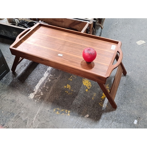 642 - Mid-Century Modern wooden breakfast tray with foldable legs, featuring integrated handles and a flat... 